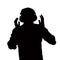 Silhouette of man listening to headphones.