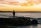 Silhouette of Man Looking the Sunset Standing on Rock Close to the Ocean.Noosa,Queensland,Australia