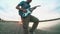 Silhouette of a man musician guitarist playing an electric guitar at sunset near the water. male guitarist concept