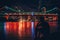 Silhouette of man near river in night city