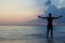 Silhouette Of Man With Outstretched Arms On Beach