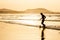 Silhouette of a man playing football soccer at sunset. Famara beach, Lanzarote, Canary Islands, Spain.