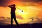 Silhouette of man playing golf at sunset