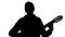 Silhouette of a man playing the guitar