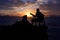 Silhouette man playing a guitar on the boat with blue sky sunrise