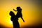 Silhouette of a man playing with his child Father`s day