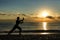 Silhouette of a man practises wing chun on the beach