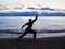 Silhouette of a man practises wing chun on the beach