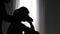 Silhouette of a man putting his hand on his girlfriend\'s shoulder to calm their sad best friends from feeling down. care,