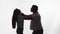 Silhouette of man from rage and anger strangling woman, white background in studio, side view. Man in fit of rage begins