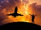 Silhouette the man raised up arms achievements successful and celebrate during airplane flying in sunset