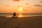 Silhouette of a man rides a bike at sunset. The men Exercise by