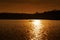 Silhouette of man rowing on the river with kayak. Sunset.