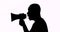 Silhouette of man speaking with megaphone