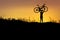 Silhouette the man stand in action lifting bicycle above his head with sunset