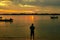 Silhouette of a man standing against a beautiful sunrise at Shela Beach in Lamu Island, Kenya
