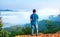 Silhouette of man standing on a high hill scenic rural hometown in the morning