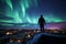 Silhouette of a man standing on the roof of his house admiring the view of aurora borealis. Sky with stars and green polar lights