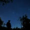 Silhouette man standing under starry sky silhouettes trees casual wear
