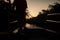 Silhouette of a man stood at the edge of a boat sailing along the Amazon River at sunset in Brazil, South America