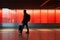 silhouette of a man with a suitcase walking through an airport