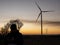 Silhouette of a man at sunset making a photo of wind turbines.wind power plants at sunset