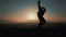 Silhouette of man on the sunset. Young successful hiker enjoys life, rejoices in life. Freedom, success concept