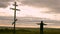 Silhouette man on top of the mountain looking with hope at the Christian Cross. A man making a confession to the cross, background