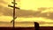 Silhouette man on top of the mountain looking with hope at the Christian Cross. A man making a confession to the cross, background