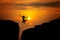 Silhouette of man travel jump up for achievements successful and