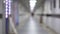 Silhouette man walking corridor. Long corridor handheld shooting. Blurred.