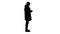 Silhouette Man in winter clothes using sanitizer spray to prevent flu disease.