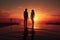 Silhouette of a man and a woman standing at the edge of a swimming pool at sunset, Silhouette of man and woman standing in