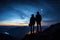 Silhouette of a man and woman on top of a mountain at night, Silhouette of young couple hiker were standing at the top of the