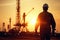 silhouette man worker. Oil drilling derricks at oilfield. Crude oil production from the ground. Mountain. Petroleum production.