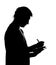 Silhouette of man writing business diary