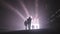 Silhouette of many construction workers walking out from a large tunnel