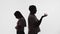 Silhouette of married couple, husband and wife standing with their backs to each other and arguing, white background in