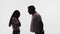 Silhouette of married couple, man yelling at woman, she covers face with hands, white background in studio. Husband