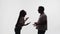Silhouette of married couple, wife swearing and arguing with husband, white background in studio, side view. Woman is