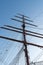 Silhouette of masts and rigging on an old sailboat under a blue sky