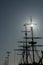 Silhouette of masts and rigging on an old sailboat under a blue sky