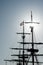 Silhouette of masts and rigging on an old sailboat under a blue sky