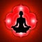 Silhouette of meditating person with root chakra symbol background