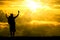 Silhouette of men backpacker open arms raised towards on hope sky at sunset light effect ,Concept for life achievements and