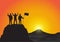 Silhouette of men on top of the mountain with fists raised up and holding flag, success, achievement, victory and winning concept