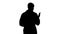 Silhouette Middle age doctor man wearing medical uniform presenting and pointing with palm of hand looking at the camera