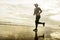 Silhouette of middle aged woman running on the beach - 40s or 50s attractive mature lady doing jogging workout enjoying fitness