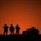 Silhouette of military soldiers team or officer with weapons and
