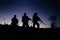 Silhouette of military soldiers with weapons at night. shot, holding gun, colorful sky. .